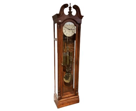 A 20th century American floor standing �tall case clock� with a swan's neck pediment and full-length glazed trunk door flanke