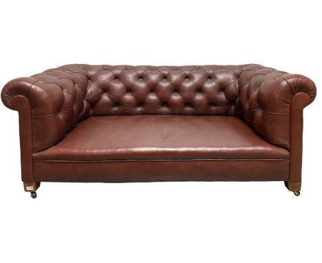 Leather Chesterfield style settee, upholstered in buttoned back brown leather, raised on ceramic castors Dimensions: Height:&