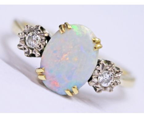 An 18ct gold diamond and opal ring, gross wt. 3.5g, size P