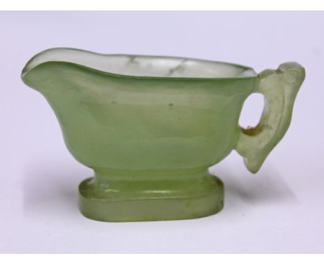 A Chinese carved jade libation cup, length 7cm