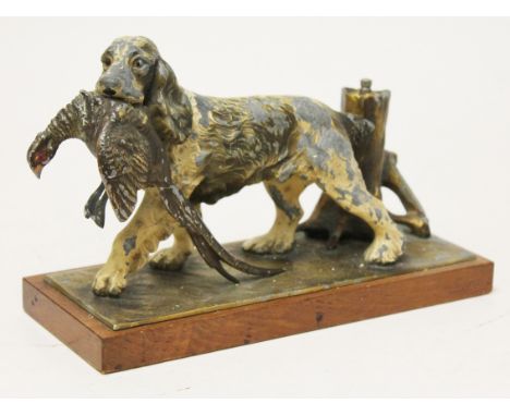An Austrian cold painted spelter table lighter formed as a dog retrieving a pheasant on wooden base, length 25cm. Condition -