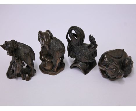A group of four Japanese carved hardwood netsuke each bearing the same signature, height approx. 5cm each