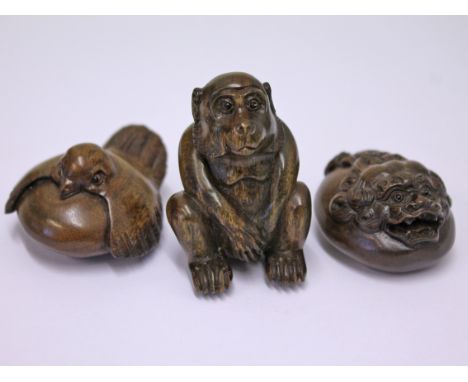A group of three Japanese carved hardwood netsuke each signed, tallest 5cm