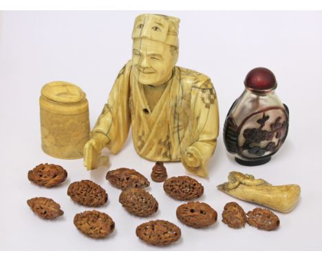 A mixed lot comprising ten finely carved wooden beads, an ivory box, half a Japanese ivory okimono and a snuff bottle