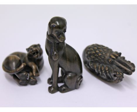 A group of three Japanese carved hardwood netsuke each signed with the same signature, tallest 5.5cm