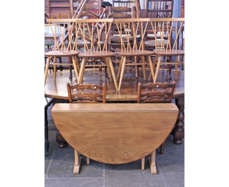 An Ercol light elm and beech drop leaf table and four twist back chairs