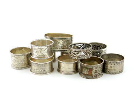 A collection of silver napkin rings, various dates and makers, oval and circular form, with pierced, engraved and engine-turn