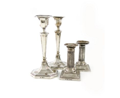 A pair of late-Victorian silver candlesticks, by William Hutton and Sons, London 1899, tapering rectangular form, canted corn