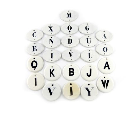 A collection of ceramic bin labels, some by W and J Burrow, circular and shaped oval form, titled in black with various lette
