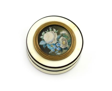 λ An early 19th century ivory snuff box, circa 1820, circular form, tortoiseshell lined, the pull-off cover with a spray of f