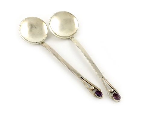 By A. E. Bonner, a pair of Arts and Crafts silver spoons, London 1913, circular bowls, pierced terminals with a ball motif an