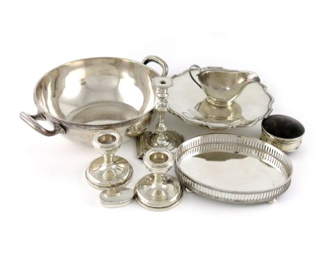 λ A mixed lot, comprising silver items: a taper stick, by George Unite, Birmingham 1906, a tazza, a silver-mounted tortoisesh