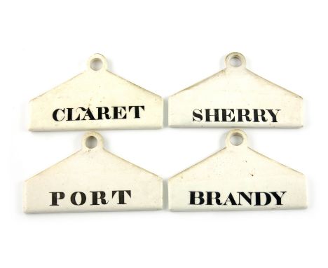 A set of four 19th century ceramic bin labels, by Minton, arched rectangular form, titled in black, 'CLARET', 'SHERRY', 'BRAN