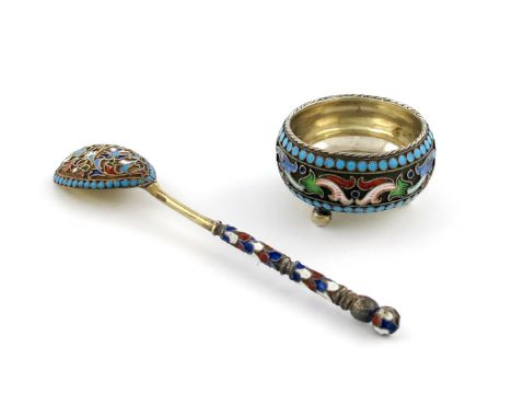 A Russian silver and enamel salt cellar, circular form, with vari-coloured foliate decoration, on three ball feet, plus a Rus