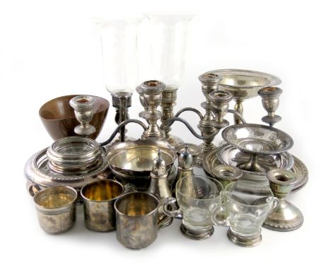 A mixed lot of American silver items, comprising: a pair of candlesticks with glass storm shades, a pair of three-light dwarf