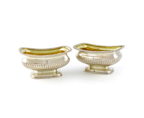 A pair of George III silver salt cellars, by Paul Storr, London 1817, rounded rectangular form, gadroon borders, gilded bowls