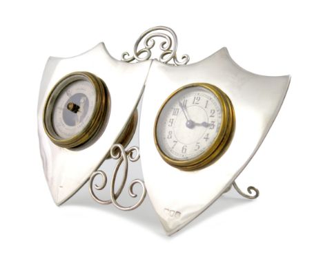 A silver clock and barometer, maker's mark worn, London 1896 of double shield form, with scroll wire-work decoration, pierced