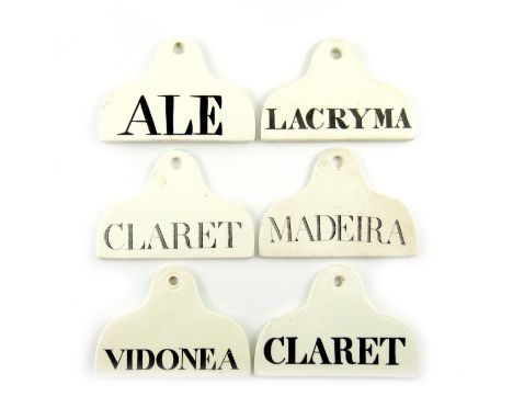 A collection of six 19th century ceramic bin labels, arched rounded rectangular form, titled in black 'ALE', 'LACRYMA', 'VIDO