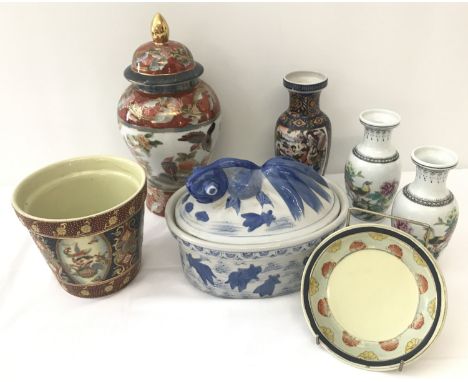 A small collection of oriental ceramics.  To include a lidded temple jar, a pair of vases and a planter.  Largest item approx