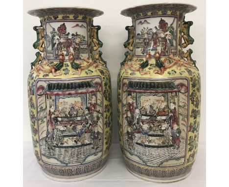A pair of large ceramic yellow ground Cantonese vases of baluster form.  With panel design depicting Imperial Court scenes, d