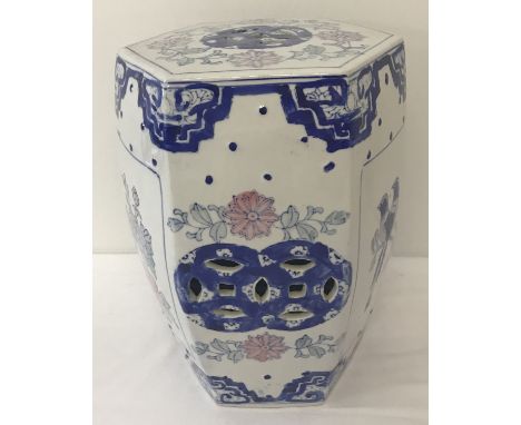 A Chinese hexagonal ceramic stool with pierced detail to sides and top. Flower and bird panel decoration to sides. Approx. 31