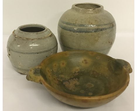 3 pieces of eastern stoneware ceramics.  2 bulbous jars with blue stripe detail together with a 2 handled shallow dish with g