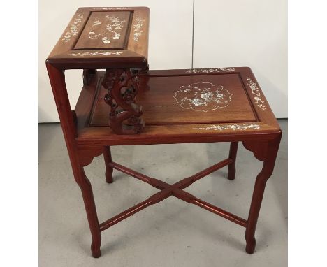 A Chinese carved hardwood 2 tier occasional table with mother of pearl inlay. A carved cherry blossom detail to upright suppo