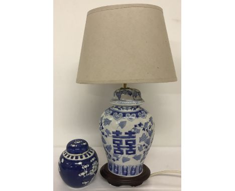 2 Chinese ceramic blue and white items.  A table lamp mounted of wooden plinth with hand painted decoration and cream shade t