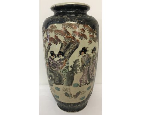 A ceramic  Satsuma vase decorated with oriental ladies in a garden.  Base marked hand painted satsuma.  Approx. 37cm tall.