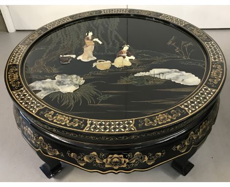 A Chinese black lacquer circular folding coffee table with mother of pearl inlay. Hand painted decoration with natural stone 