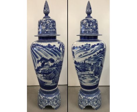 A very large Chinese blue and white ceramic lidded urn on a seperate pedestal base. Hand painted with Chinese landscape scene