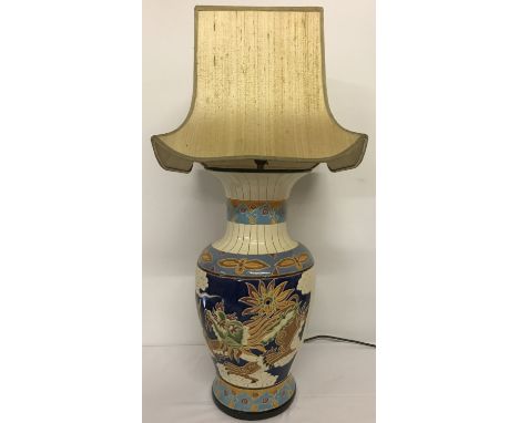 A large Chinese ceramic urn shaped table lamp with colourful dragon panel design.  Together with a pagoda shaped cream lamp s