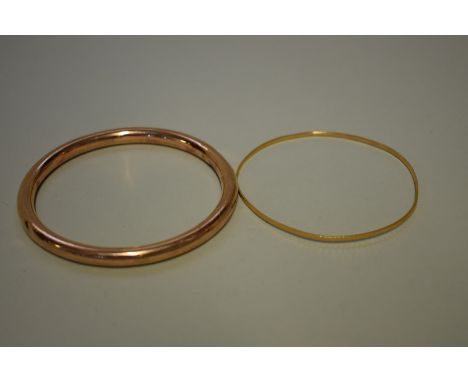 A bright cut gold bangle, stamped 18c,&nbsp;4.4g; together with a gold bangle, hallmarked 375, 9.8g. (2) 