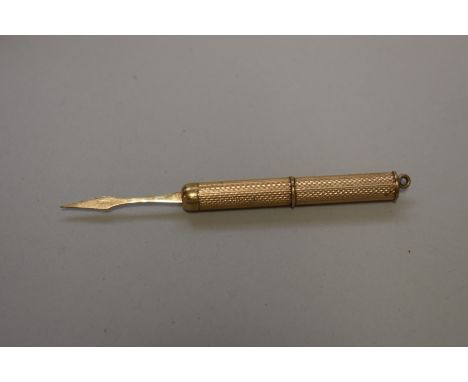 An engine turned gold toothpick, hallmarked 9ct,&nbsp;4cm long,&nbsp;5.3g total weight. 