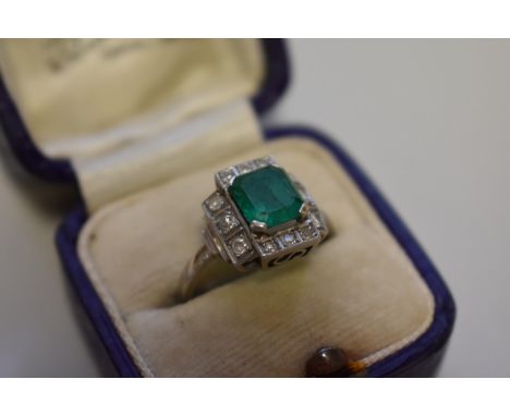 An Art Deco style square cut emerald and diamond unmarked white gold ring, 4.5g total weight. 