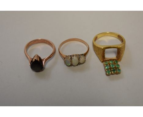 Three gem set unmarked yellow metal rings,&nbsp;set opal; emerald; and obsidian, 10.7g total weight. (3) 