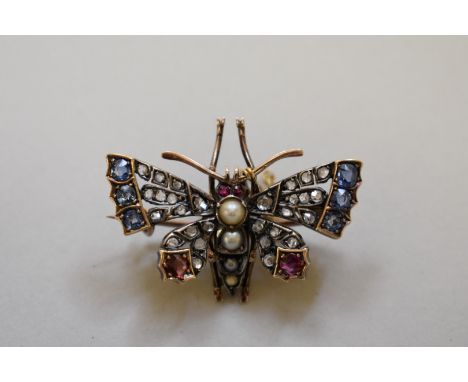 A Victorian 'butterfly' pendant brooch, having mine cut diamond, sapphire&nbsp;and ruby set wings, a pearl body mounted in un