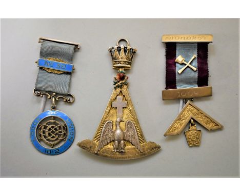 A silver gilt and enamel Masonic jewel,&nbsp;by Spencer, London, 8.5cm high; together with two silver Masonic medals. (3) 