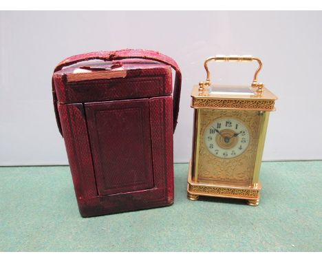 A late 19th/early 20th Century brass carriage clock with ornate pierced case. The enamel dial with Arabic numerals contained 