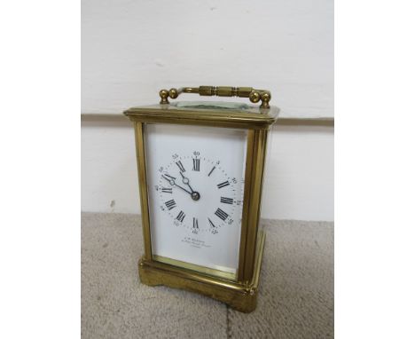 A late 19th Century brass carriage clock, Roman enamel dial with Roman numerals signed JW Benson (hairlined), with key, 11cm 
