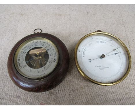 A Negretti and Zambra, London gilt brass aneroid barometer and another 