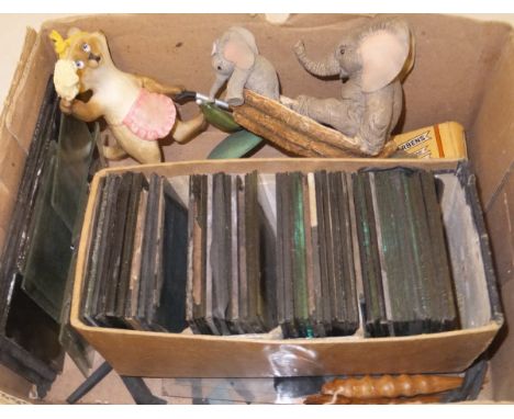 A box containing an assortment of sundry figures and a collection of 19th Century magic lantern slides to include cartoon fig