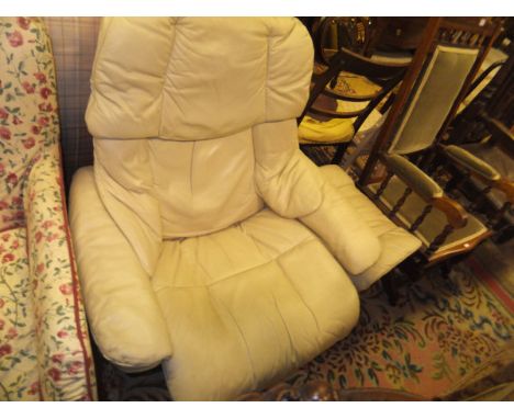 An Ekornes Stressless leather upholstered armchair and stool and a circa 1900 stained beech framed rocking armchair