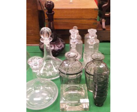 An Orrefors glass ship's decanter, another ship's decanter, a Bohemian ruby overlaid cut glass decanter, an etched and facet 