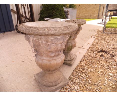 A pair of composite stone garden urns CONDITION REPORTS There are several chunks missing from each planter, there are drill h