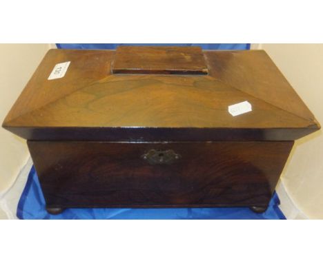 A late Regency rosewood tea caddy of sarcophagus form, the top opening to reveal two canisters and central recess, raised on 