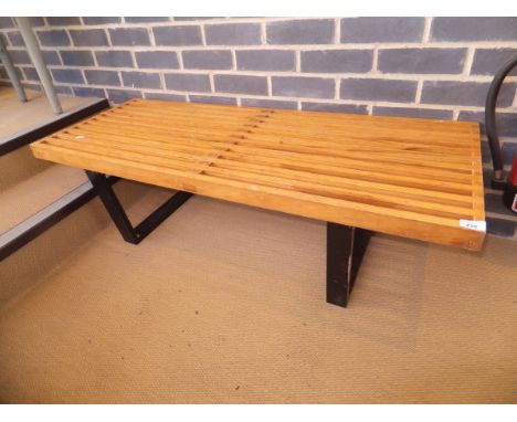 A slatted wooden bench with black stained supports in the manner of George Nelson for Hermann Miller  CONDITION REPORTS Varni