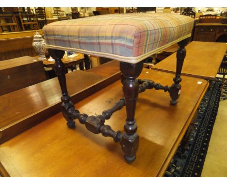 An 18th Century walnut stool, the upholstered chequered seat on turned supports united by stretchers