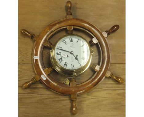 An oak cased mantel clock with Arabic numerals to the silvered dial on ogee bracket feet, a Napoleon hat shaped mantel clock 