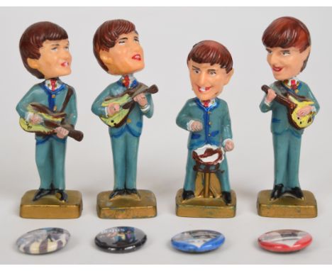 The Beatles set of four vintage cake topper bobble head / nodding caricatures of the band members, height 9cm, together with 
